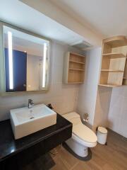 Modern bathroom with sink, mirror, and toilet