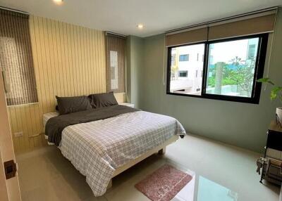 Modern bedroom with large bed and windows