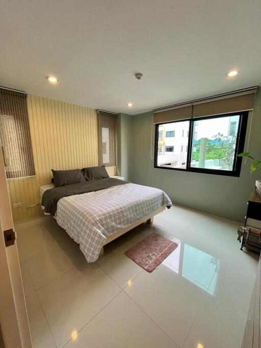 Modern bedroom with large bed and windows