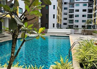 Outdoor pool view with modern apartment buildings