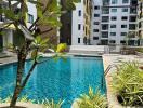 Outdoor pool view with modern apartment buildings