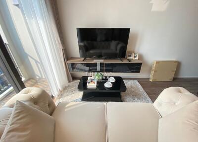 Modern living room with a flat-screen TV, coffee table, and cozy couch