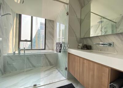Modern bathroom with large window and glass-enclosed shower