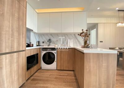 Modern kitchen with wooden cabinets and marble backsplash