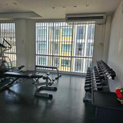 Fitness room with exercise equipment and large windows