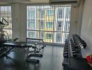 Fitness room with exercise equipment and large windows