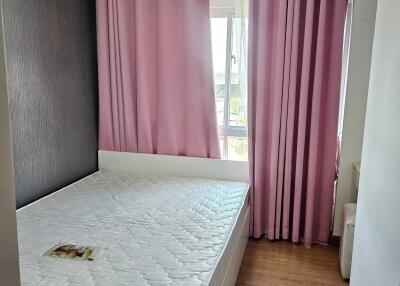 Bedroom with bed and pink curtains