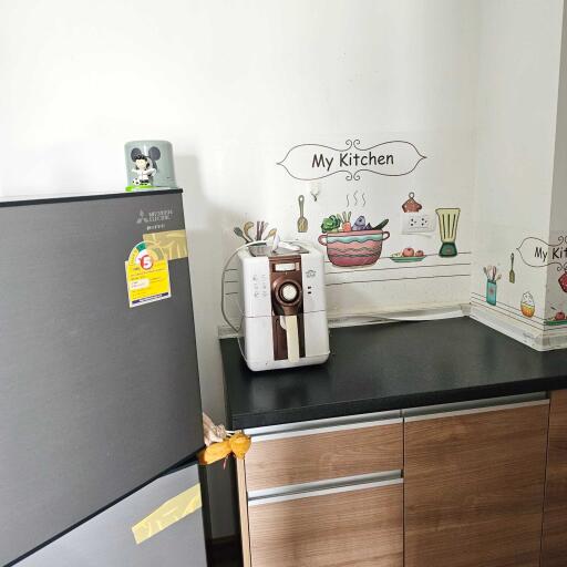 Compact kitchen corner with appliances and decor