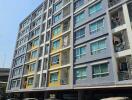 Exterior view of a multi-story residential building with balconies