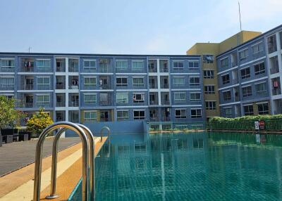 Outdoor swimming pool with apartment building in background