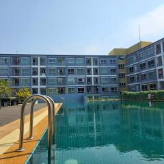 Outdoor swimming pool with apartment building in background