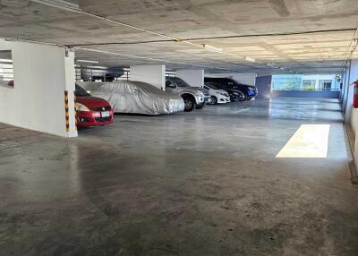 Indoor parking garage with several parked cars