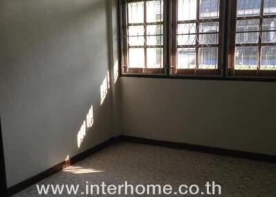 Empty bedroom with air conditioning and large window