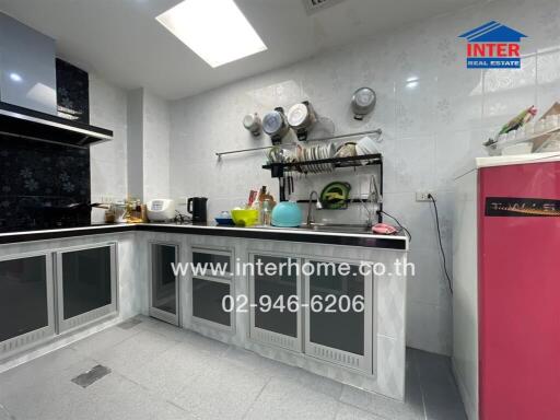 Modern kitchen with stainless steel counters and appliances