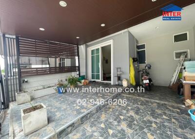 Covered outdoor area with tiled flooring and plants