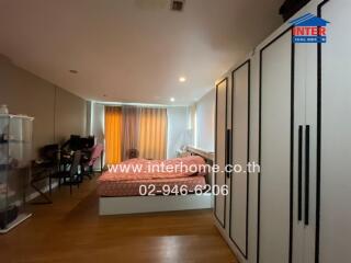 Spacious bedroom with work desk and large wardrobe