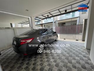 Covered garage with a parked car