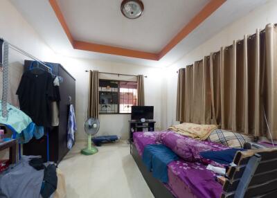 Spacious bedroom with window, bed, wardrobe, and various furnishings