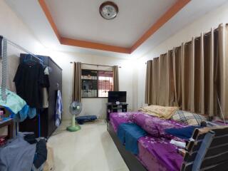 Spacious bedroom with window, bed, wardrobe, and various furnishings