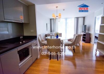 Modern living space with kitchenette, dining area, and seating area