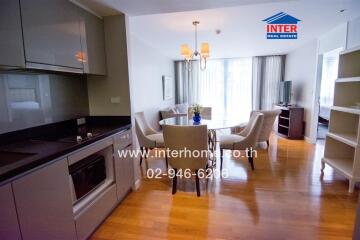 Modern living space with kitchenette, dining area, and seating area