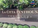 La Citta Penthouse entrance sign with lush greenery