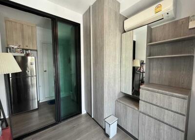 Bedroom with built-in wooden wardrobe and mirror