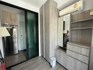 Bedroom with built-in wooden wardrobe and mirror