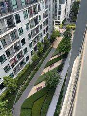 Aerial view of a modern residential apartment complex with landscaped gardens