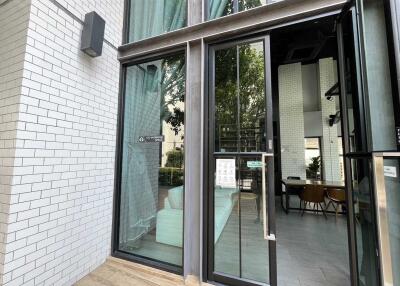 Glass entrance doors to modern building with interior view