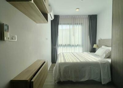Modern bedroom with wooden furniture and large window