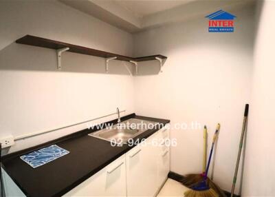 Small kitchenette with sink and storage