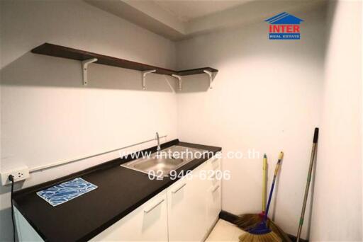 Small kitchenette with sink and storage