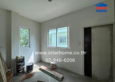 Unfurnished room with windows and painting supplies