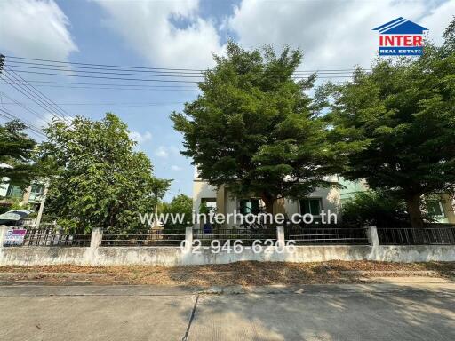 Front view of a house with greenery and trees