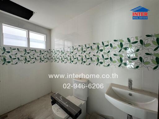 Bathroom with sink, toilet, and patterned tile