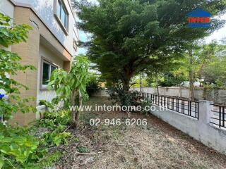 Exterior view of a property with a garden and trees