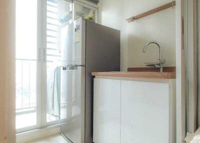 Compact modern kitchen with fridge and sink