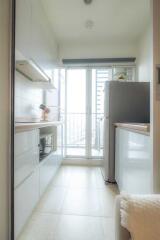 Modern kitchen with sleek cabinetry and large windows