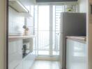 Modern kitchen with sleek cabinetry and large windows