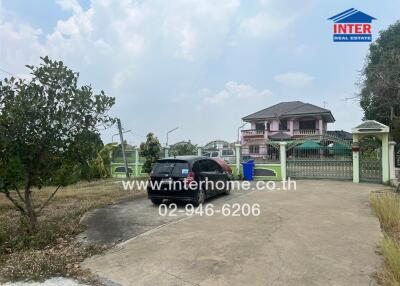 Front exterior of a property with driveway and parked car