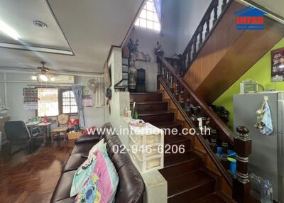 Living room with staircase and dining area