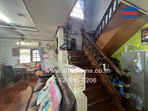 Living room with staircase and dining area