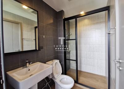 Modern bathroom with glass shower enclosure and basin