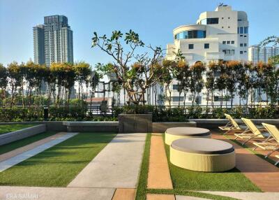 Rooftop garden with seating area and city view