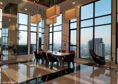 Modern dining space with large windows and city view