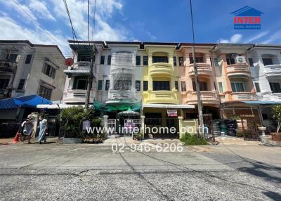 Row of multi-colored townhouses with street view