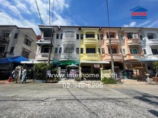 Row of multi-colored townhouses with street view