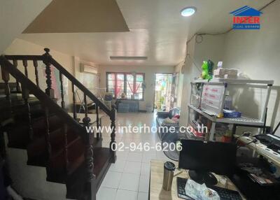 Spacious living area with work desk and stairway