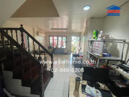 Spacious living area with work desk and stairway